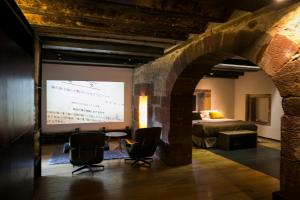 a room with two chairs and a projection screen at Hotel Boutique El Convento de Mave in Santa María de Mave