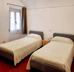 Säng eller sängar i ett rum på Ninì - Casa medievale nel borgo