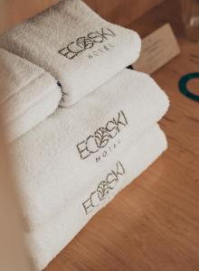 three towels on a table with the words royale on them at Hotel EcoSki by bund in San Carlos de Bariloche