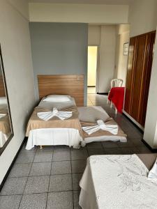Voodi või voodid majutusasutuse Piúma Palace Hotel toas