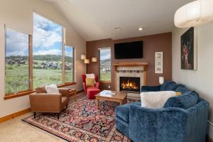 a living room with two couches and a fireplace at 2002 Lupine Lane in Tabernash