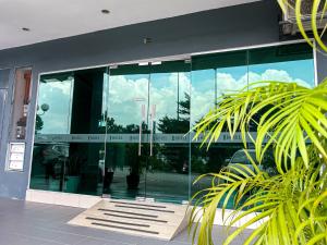a glass facade of a building with a lot of windows at 1 Hotel Mahkota Cheras in Kuala Lumpur