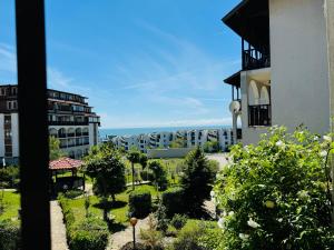a view of a building with a garden in front of it at VODENICATA 7 Apartment Sveti Vlas in Sveti Vlas
