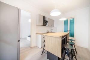 a kitchen with a counter and stools in a room at Carrer de Santa Madrona, 1 in Barcelona