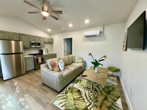 a living room with a couch and a kitchen at Bird of Paradise - 544A in Sarasota