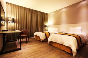מיטה או מיטות בחדר ב-Sankaikan Hotel