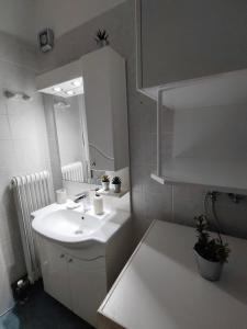 a bathroom with a white sink and a mirror at The cozy seaside apartment in Nafpaktos +70 photos