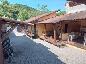 a house with a porch and a patio at Vila do Surfe in Ubatuba