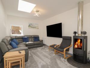 a living room with a couch and a fireplace at The Laurels in Fraserburgh