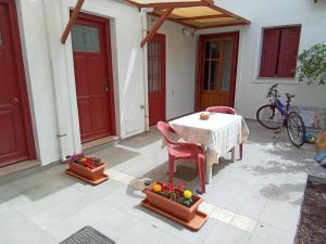 a patio with a table and chairs and a bike at Agapis Apartments in Petra