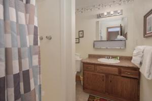 a bathroom with a sink and a mirror at Hideaway Village Alpine 4 in Winter Park +13 photos