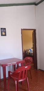 stół i 2 czerwone krzesła w pokoju w obiekcie Casa Montemar Hotel-San Vicente w mieście San Vicente