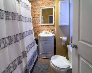 a bathroom with a white toilet and a sink at Casa Coquette+Near VA Hosp, MVP Arena & Law School in Albany