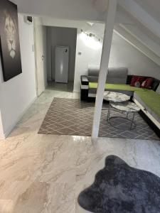 a living room with a couch and a table at Apartman Sun house Kumbor 2 in Herceg-Novi