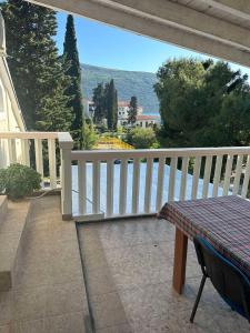 a balcony with a table and a white fence at Apartman Sun house Kumbor 2 in Herceg-Novi