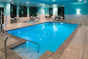 a large swimming pool in a hotel room at Hilton Garden Inn Seattle Lynnwood, Wa in Lynnwood