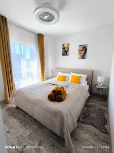 a bedroom with a large bed with a large window at Kamiles apartamentai in Palanga