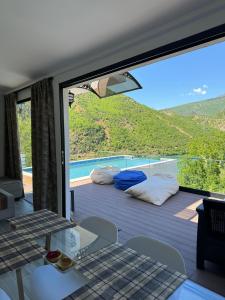 a room with a large window with a bed on a balcony at Koman Paradise by Romina in Shkodër