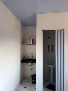 a bathroom with a sink and a toilet at Suites do Rafa Ubatuba in Ubatuba