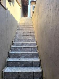 a stairway with steps leading up to a building at Suites do Rafa Ubatuba in Ubatuba