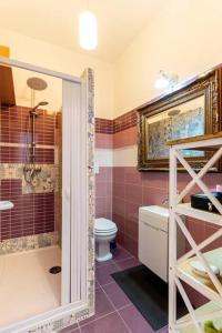 a bathroom with a shower and a toilet and a sink at GuestHouse Pet's Friendly in Quattromiglia