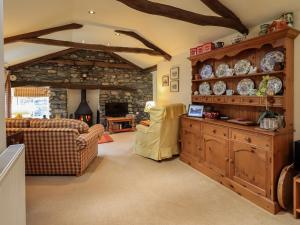 a large living room with a stone wall at Beckside Studio in Patterdale