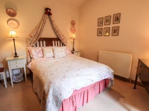 a bedroom with a large bed with a canopy at Beckside Studio in Patterdale