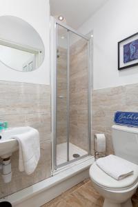a bathroom with a shower and a toilet and a sink at Air Host and Stay - Spacious 5-Bed Retreat in Edge Grove Sleeps 9 in Liverpool
