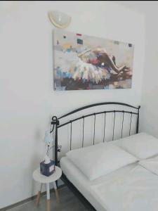 a bedroom with a bed and a painting on the wall at Holiday Home Bepo in Sevid +33 photos