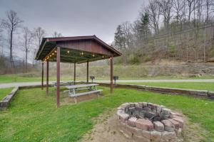 a picnic shelter with a picnic table and a fire pit at Riverfront Briceville Studio Apt ATV, Hike and More 