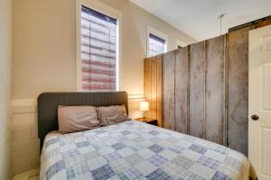 a bedroom with a bed and a wooden wall at Riverfront Briceville Studio Apt ATV, Hike and More 