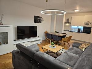 ein Wohnzimmer mit einem Sofa und einem Tisch in der Unterkunft OSIJEK SPACE CENTAR - Free self check in, Free private parking in Osijek