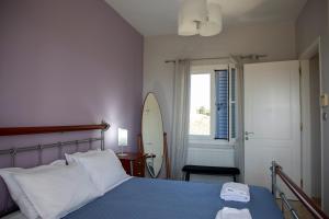 a bedroom with a bed and a surfboard in it at The Garden House in Egina