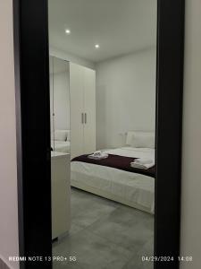 a bedroom with a bed and a mirror at One bedroom TEA apartment Il-Gzira in Il-Gżira