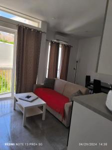 a living room with a couch and a table at One bedroom TEA apartment Il-Gzira in Il-Gżira