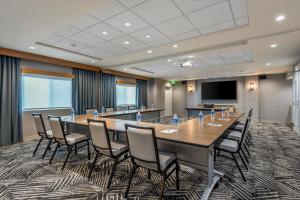 a conference room with a large table and chairs at Hyatt Place Phoenix Chandler - Fashion Center in Chandler
