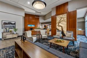 a lobby with a couch and chairs and a table at Hyatt Place Phoenix Chandler - Fashion Center in Chandler