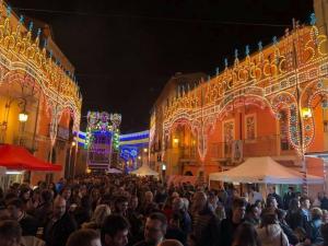 a crowd of people standing in a street at night at Casa Vacanze Lappe in Pratola Peligna