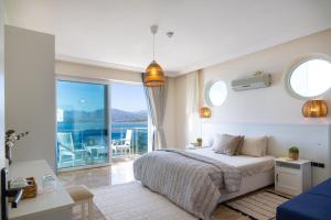 a bedroom with a bed and a view of the ocean at Sofia Ada in Fethiye