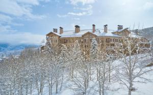 a large building on top of a snow covered mountain at Woodrun Place in Snowmass Village