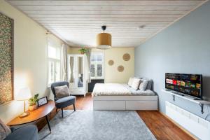 a bedroom with a bed and a desk and a tv at Garden Studio next to Telliskivi & Old Town in Tallinn