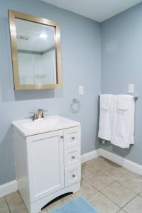 a bathroom with a sink and a mirror and towels at King Bed/ apartment/Free St Parking/ Quiet in Philadelphia
