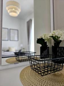 a mirror with two baskets with flowers on a table at Apartment Melani in Vir