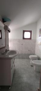 a bathroom with a sink and a toilet at Casa Marecielo - Attico con terrazza panoramica vista mare in Longobardi