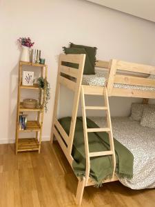 a room with a bunk bed with a ladder and a shelf at Garden Hill Apartment in Albufeira