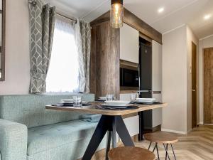 a dining room with a table and a couch at Brookwood in Weston-super-Mare