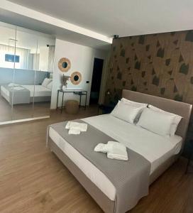a bedroom with a large bed with two towels on it at Nanas luxury and cozy apartment in Thérissos