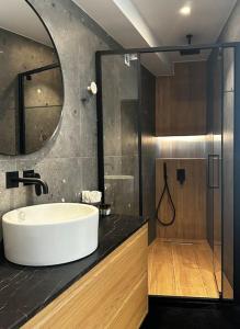 a bathroom with a white sink and a shower at Nanas luxury and cozy apartment in Thérissos +14 photos