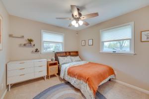 a bedroom with a bed and a ceiling fan at Modern Urbana Home 2 Mi to University of Illinois in Urbana