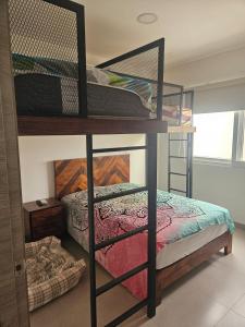 a room with two bunk beds and a bed at Villa Country Club Salinas in Salinas